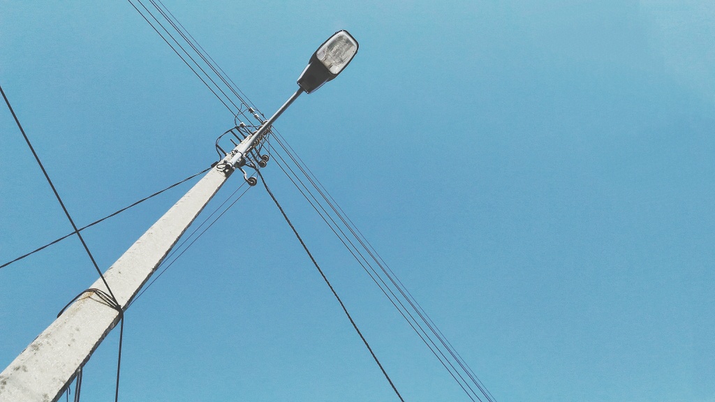 low-angle-view-electricity-pylon-against-clear-blue-sky.jpg